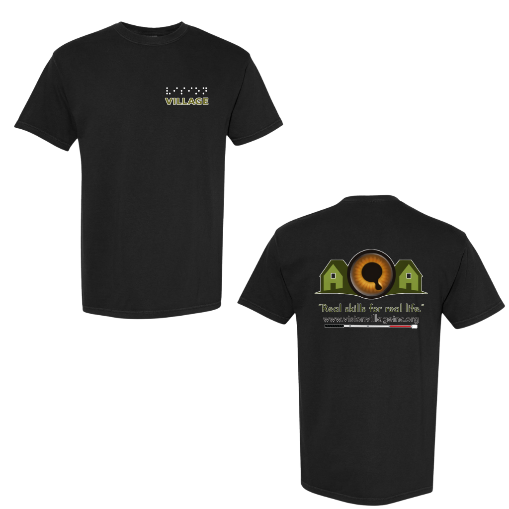 Black t-shirt with left chest graphic on the front that has the word vision in braille and the word village in print. The back has the Vision Village logo with the words “real skills for real life” underneath. Below that is the non-profit’s email address, www.visionvillageinc.org, and a graphic of a white cane.
