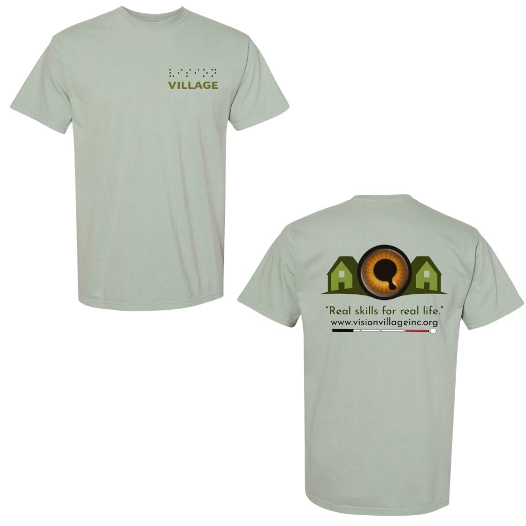 Bay t-shirt with left chest graphic on the front that has the word vision in braille and the word village in print. The back has the Vision Village logo with the words “real skills for real life” underneath. Below that is the non-profit’s email address, www.visionvillageinc.org, and a graphic of a white cane.