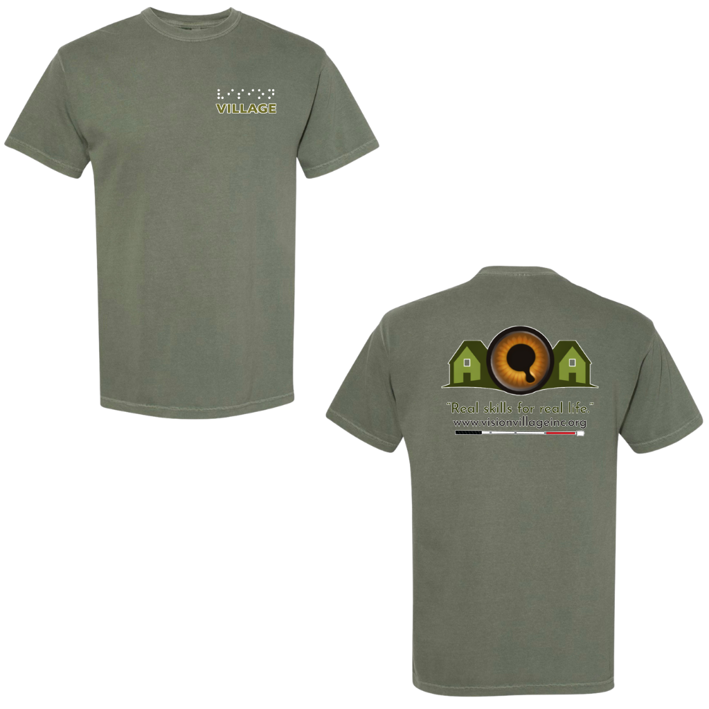 Moss t-shirt with left chest graphic on the front that has the word vision in braille and the word village in print. The back has the Vision Village logo with the words “real skills for real life” underneath. Below that is the non-profit’s email address, www.visionvillageinc.org, and a graphic of a white cane.