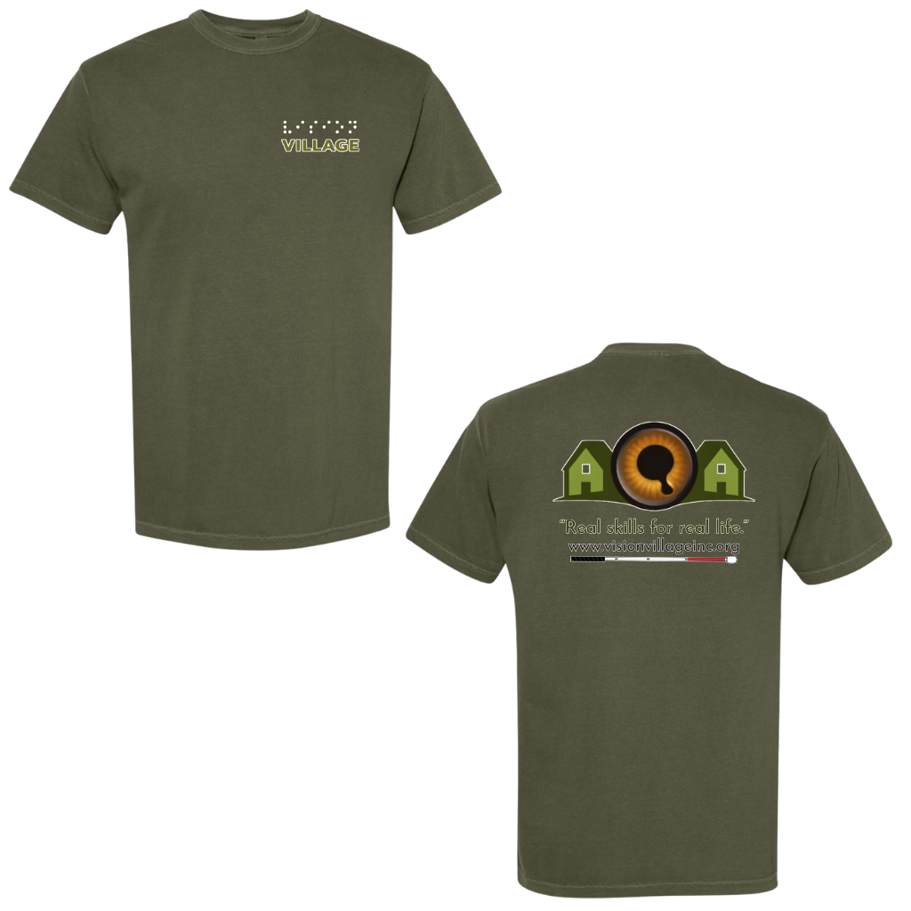 Sage t-shirt with left chest graphic on the front that has the word vision in braille and the word village in print. The back has the Vision Village logo with the words “real skills for real life” underneath. Below that is the non-profit’s email address, www.visionvillageinc.org, and a graphic of a white cane.
