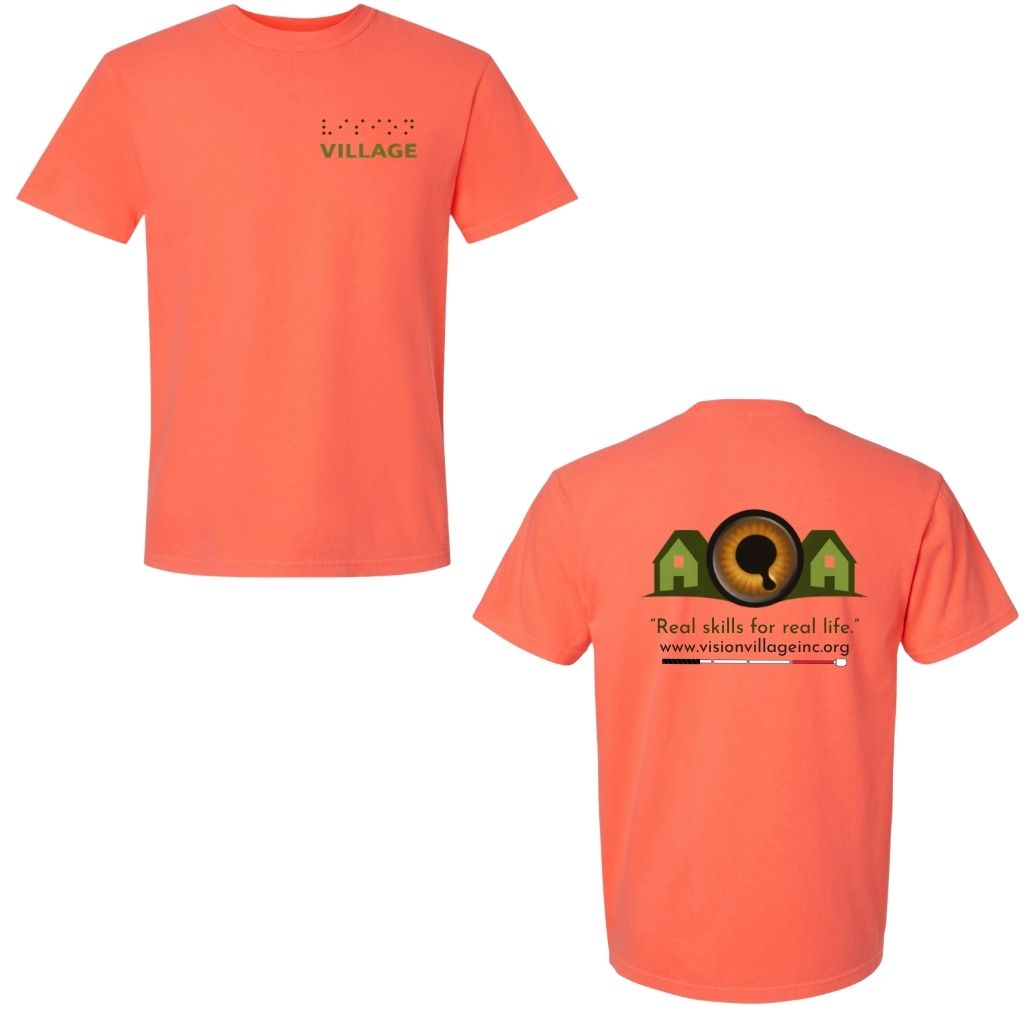 Neon red orange t-shirt with left chest graphic on the front that has the word vision in braille and the word village in print. The back has the Vision Village logo with the words “real skills for real life” underneath. Below that is the non-profit’s email address, www.visionvillageinc.org, and a graphic of a white cane.