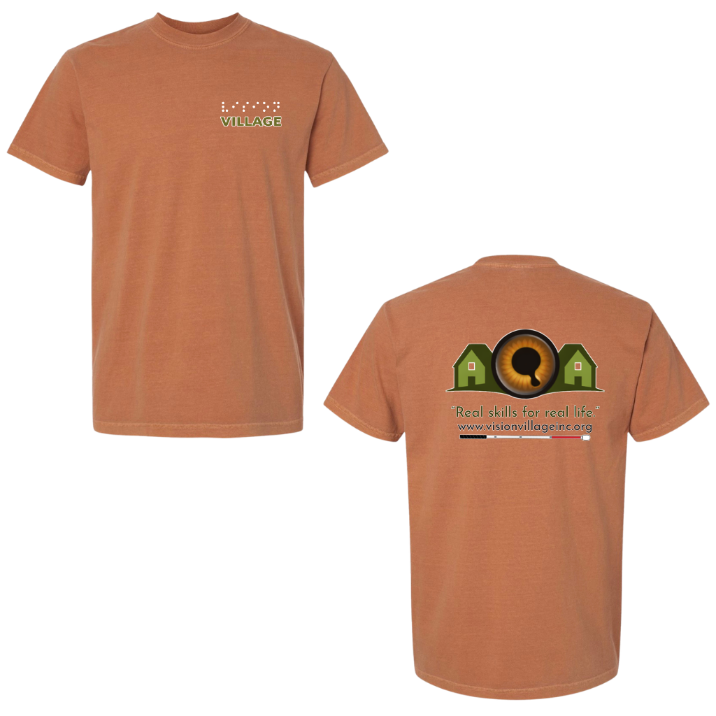 Yam t-shirt with left chest graphic on the front that has the word vision in braille and the word village in print. The back has the Vision Village logo with the words “real skills for real life” underneath. Below that is the non-profit’s email address, www.visionvillageinc.org, and a graphic of a white cane.