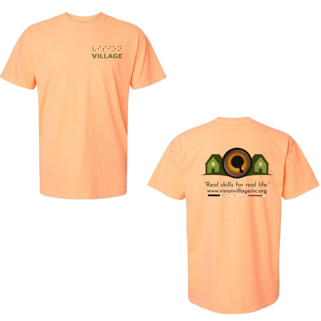 Neon cantaloupe t-shirt with left chest graphic on the front that has the word vision in braille and the word village in print. The back has the Vision Village logo with the words “real skills for real life” underneath. Below that is the non-profit’s email address, www.visionvillageinc.org, and a graphic of a white cane.