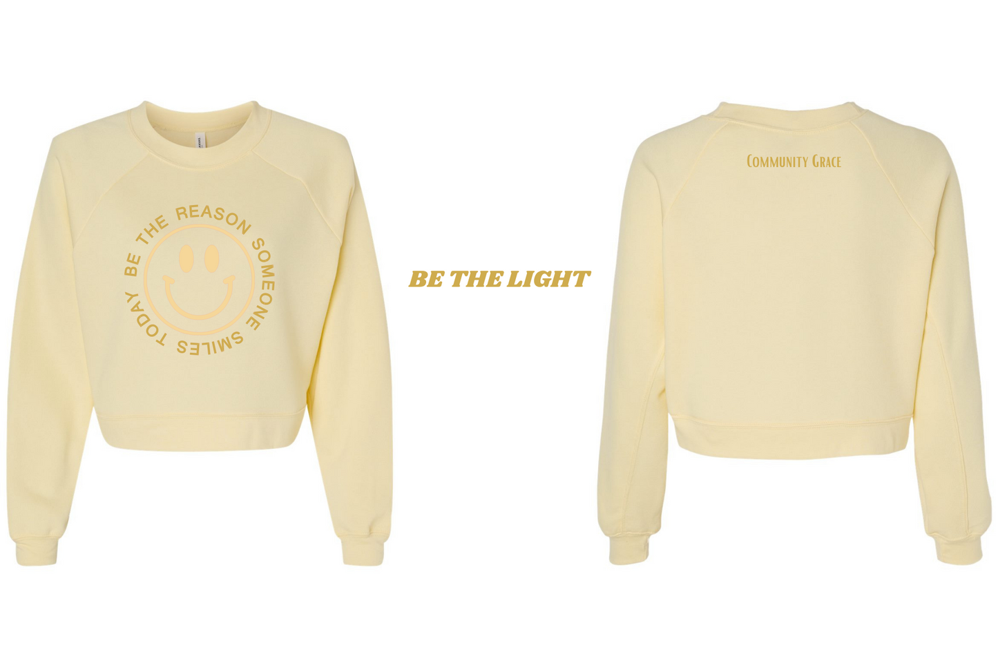 yellow cropped crewneck sweatshirt with a smiley face in a vibrant yellow tone with the words "BE THE REASON SOMEONE SMILES TODAY" around it in capital letters in a gold tone on the front of the sweatshirt. On the back of the sweatshirt is Community Grace in a gold tone. The inner left sleeve of the sweatshirt has the affirmation "Be The Light"